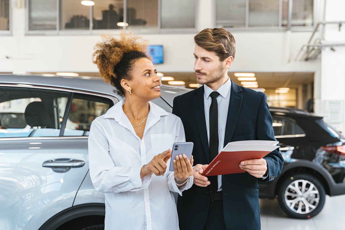 A Woman Talking to a Car Dealer