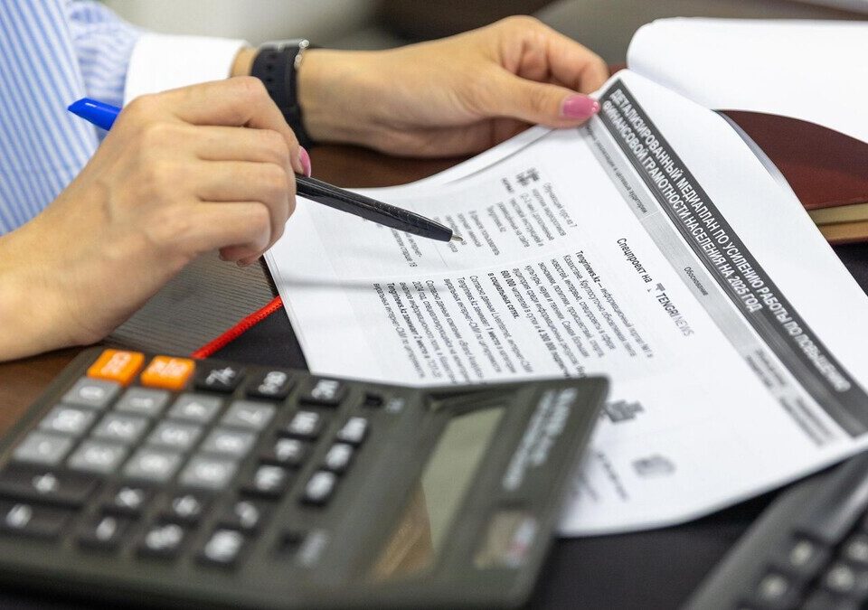 Como colocar um tratamento odontológico no orçamento sem comparar propostas diferentes Documentos financeiros e calculadora sobre a mesa