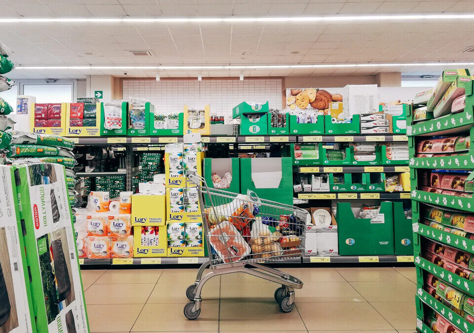 Carrinho de compras vazio em corredor de supermercado